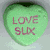 Four heart-shaped candy icons with text: green 'LOVE SUX', purple 'DIE', pink 'GO TO HELL', and a blank fourth space.