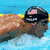 Pixelated image of a person in swimwear holding a camera against a blue background with yellow accents.