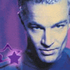 A person with short light hair wears a blue top against a purple background with a purple star symbol.