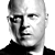 A black-and-white and red promotional image for the TV show 'The Shield' featuring a bald man in a dark shirt with text indicating broadcast times on FX.