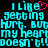 Pixelated cyan text on black background with pink heart symbol, repeating 'I like getting hurt but my heart doesn't' in multiple lines.