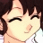Pixelated anime-style character with brown hair and closed eyes smiling, next to black background with white text 'Anime IM' and 'COM' in pixelated font.