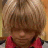 A young person with light brown hair and bangs wears a red shirt, shown in three where the head position shifts slightly left to right