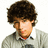A pixelated image shows a person with curly brown hair wearing a light gray shirt against a white background, next to pink text reading "Nick!" and "Joe!" on black.