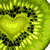 A static pixel art icon showing a sliced kiwi fruit with a heart-shaped center, surrounded by green flesh and black seeds, on a white background.