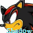 Pixelated character with black fur, yellow ears, red markings on head, white muzzle, and blue-tinted lower face.