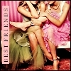 Three women in colorful dresses embrace closely against a pink striped background with vertical text reading BEST FRIENDS.