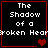 Four identical black square with red borders display white pixelated text reading "The Shadow of a Broken Heart" and one or two red heart symbols