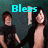 Two people stand against a dark teal background with cyan text changing across frames.