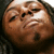 A person with dark skin and long hair appears in a of four , showing subtle facial expression changes across the sequence