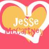 A static icon featuring a heart-shaped design with yellow-orange inner sections and white outlines on a red background, overlaid with text reading "Jesse McCartney".