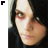 A pixelated close-up of a person with dark hair and light skin, showing two side-by-side views where the right view is slightly cropped on the left edge.