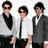 Four views of a person with brown curly hair wearing sunglasses, showing different outfits and poses against white backgrounds.