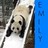 Pixelated image of a panda's face with black and white fur, dark eyes, and a blue background on the right side.