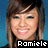 Pixelated portrait of a smiling person with long brown hair against blue background, text 'Romiele' at bottom.