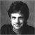 A black-and-white pixelated portrait of a person with dark hair and a collared shirt, next to green text reading 'Original Icons .com' on a solid background.
