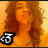 A woman with long curly brown hair in a yellow top appears across four , the leftmost contains a black and white 'T' symbol
