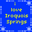 Blue background with yellow text reading "i love Iroquois Springs" arranged in a pattern, surrounded by white snowflake and dotted-line border elements