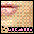 Pixelated image with pastel checkered background, pink lips in upper left, black heart symbols on lower left, and 'GORGEOUS' text in pink block letters at bottom.