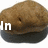 Brown textured object with dark base and white text reading 'In Your FACE!!' across three
