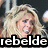 Pixelated image of a person with long blonde hair wearing a purple skirt and black top, with overlaid text reading 'rebelde dulce' and 'marija'.