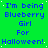 Green background with blue pixelated text repeating 'I'm being Blueberry Girl For Halloween!' in a pattern, featuring scattered white dots