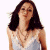 A pixelated image of a woman with long dark hair wearing a light-colored sleeveless top, positioned next to green text on a dark background.