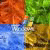 A pixelated static image divided into four quadrants of solid color: orange top-left, green top-right, blue bottom-left, and brownish-yellow bottom-right.