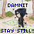 Pixelated character with black hair and dark clothing stands in a park-like background, text above reads "DAMNIT I CANT HIT" and below "STAY STILL!! THE APPLE!"