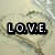 Pixelated text 'LOVE.' in white block letters on black rectangular backgrounds, set against a muted beige and gray abstract pattern.