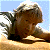 A pixelated contact sheet showing two frames of an animated icon featuring a crocodile hunter statue and green text on a dark background.