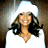 Static 48x48 pixel icon of a person with long dark hair and light skin wearing a white top, set against a bright background with brown side elements.
