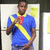 A person in a blue polo shirt with yellow diagonal stripe and red collar holds a red object near their face against a light background with yellow sticky notes.