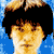 Pixelated portrait of a person with dark hair and light skin, displayed in a four- with varying color saturation and brightness levels