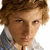 Pixelated image of a person with light brown hair and a white-collared shirt on the left, next to green text reading 'Alex Pettyfer' on a purple background.