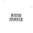 Pixelated text 'ANNE MARIE' repeated across white background with scattered blue, purple, and pink geometric shapes.