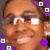 A pixelated face with brown skin and dark hair, wearing white square glasses, surrounded by purple and white geometric shapes including squares and a heart.