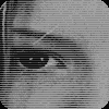 A pixelated face with dark eyes and a neutral expression, displayed in two color variations: grayscale on the left and yellow-tinted on the right.