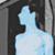 Pixelated light blue figure with simplified head and torso against dark background, no visible facial features or clothing details.