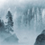 Pixelated static image with abstract shapes in muted blue and gray tones against a light background.