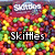 A pixelated image of colorful Skittles candies with text overlays reading "Skittles," "See the Rainbow," and "Taste the Rainbow" across different sections.
