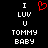 A black background displays white pixelated text reading "I LUV U TOMMY BABY" with a red heart symbol replacing the 'L' in LUV on one side.