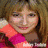 A static image of a person with light brown hair wearing a pink and orange striped garment, partially visible text at the bottom.