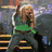 Pixelated figure with light brown hair in a green top and dark pants, standing against a blurred background of indistinct shapes.
