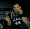 A person in a dark jersey with 'MAD 44' text holds up two fingers, transitioning through multiple poses