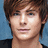 Pixelated image of a person with brown hair and blue eyes, split into four quadrants with text overlays in cyan pixel font on black backgrounds.