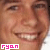 A static close-up of a smiling person's face with visible teeth, featuring pink text reading 'ryan' in the bottom-left corner.