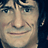 Static 48x48 pixel icon showing a close-up of a man's face with light skin tone, dark hair, and visible facial features including eyes, nose, mouth, and cheekbones against a dark background.