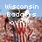 Pixelated image with white text over a blurred background showing red and brown tones under a light blue sky.