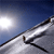 Pixelated static image of a snow-covered slope with ski tracks under a bright sky, likely representing a winter sports scene.
